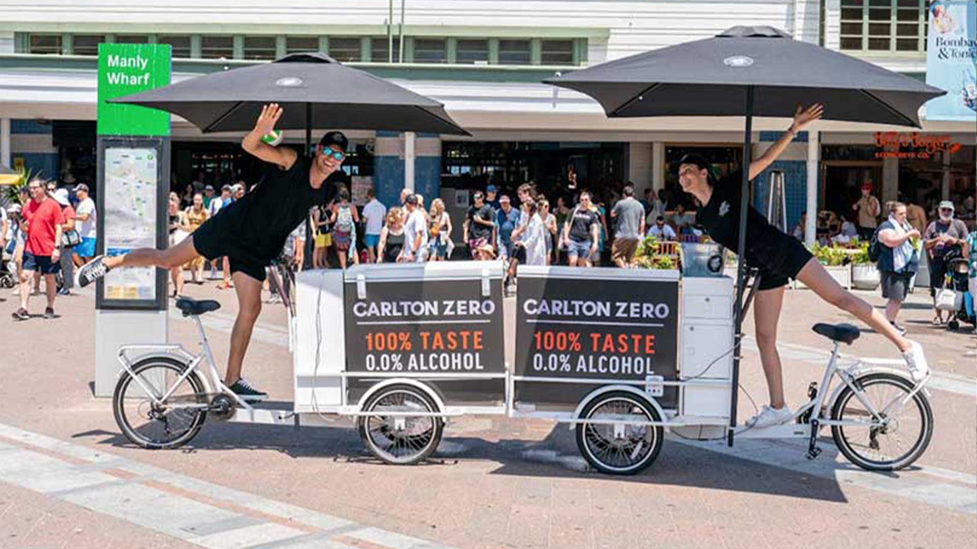 two people standing on branded coffee carts